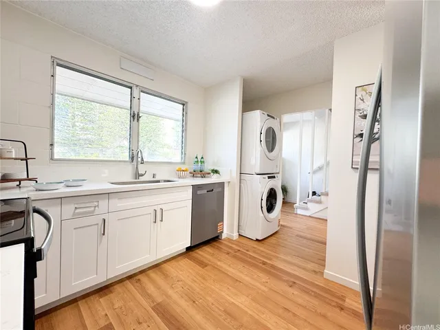 a kitchen with a refrigerator and white cabinets
