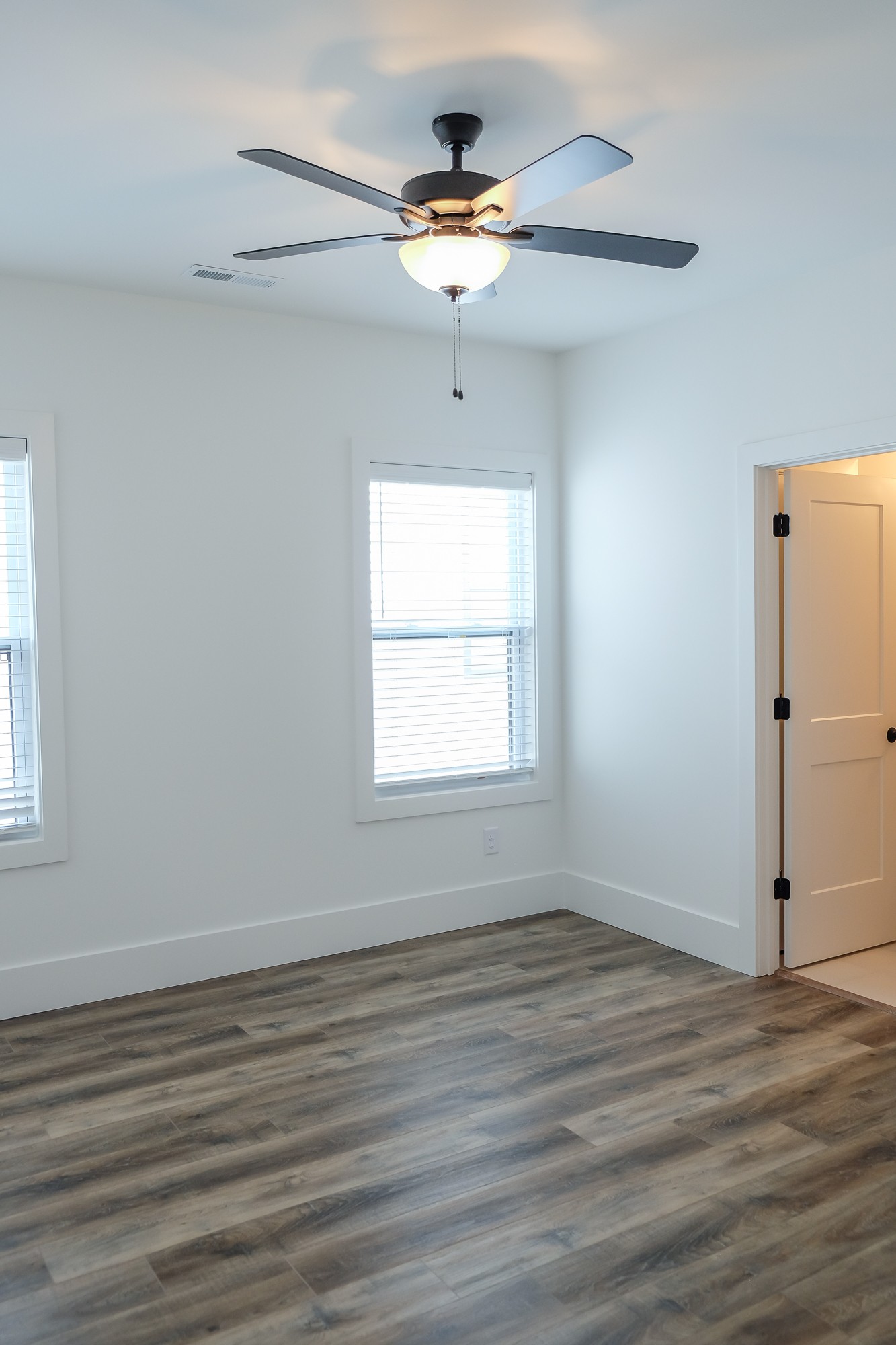 2818 Valley Road Nashville, TN 37215 - Photo 17 of 21 an empty room with wooden floor chandelier fan and windows
