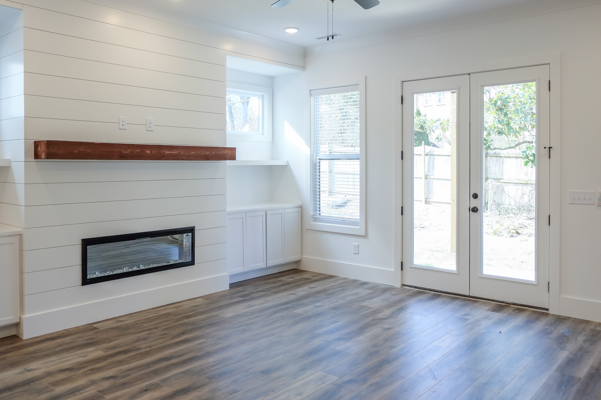 2818 Valley Road Nashville, TN 37215 - Photo 5 of 21 an empty room with wooden floor fireplace and windows
