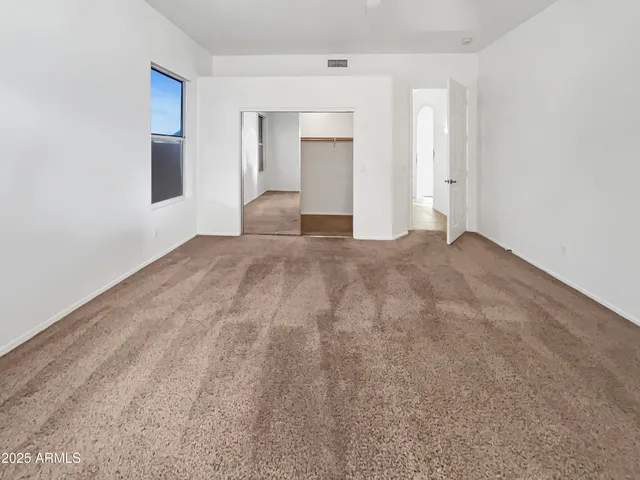 a spacious bathroom with a granite countertop sink mirror and bathtub