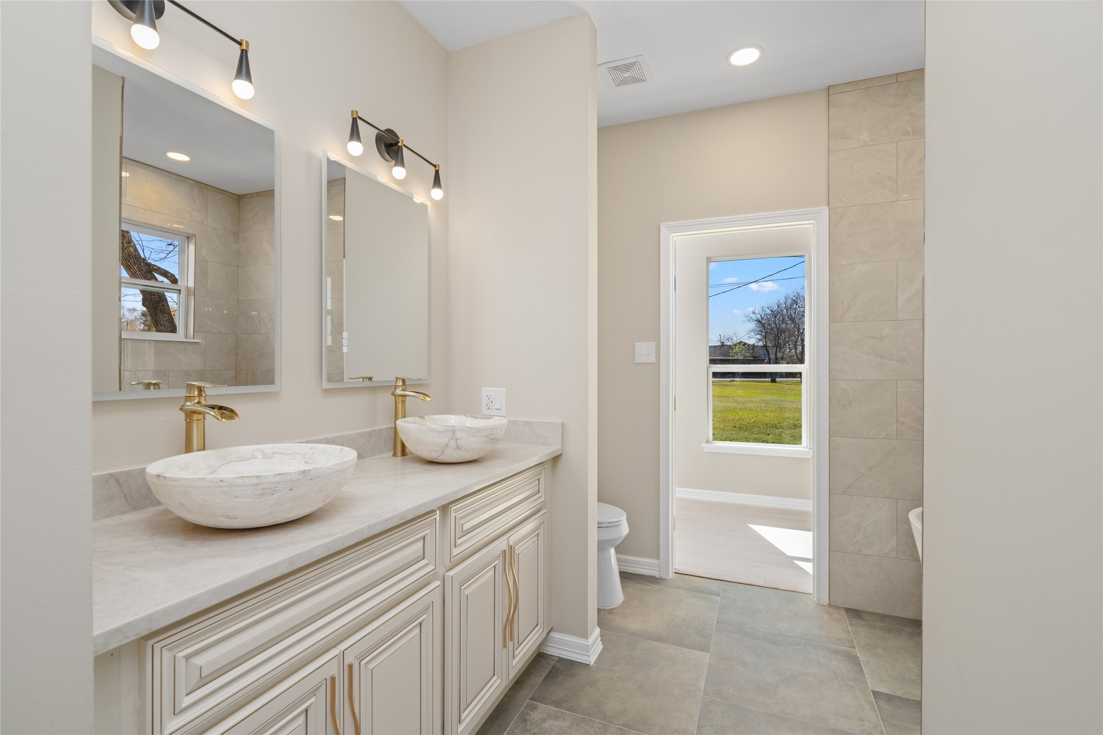 4654 North Teague Street Rosharon, TX 77583 - Photo 31 of 46 Luxurious master bath
retreat with dual vessel
sinks, elegant vanity, and a
spa-like ambiance. Natural
light flows in, creating a
serene start to your day."