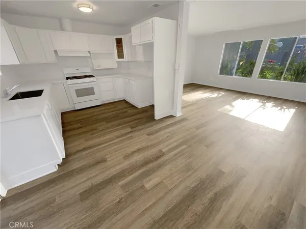 a kitchen with stainless steel appliances a refrigerator and a stove top oven