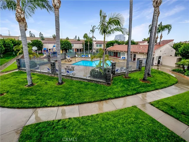 a aerial view of a house with a garden and lake view