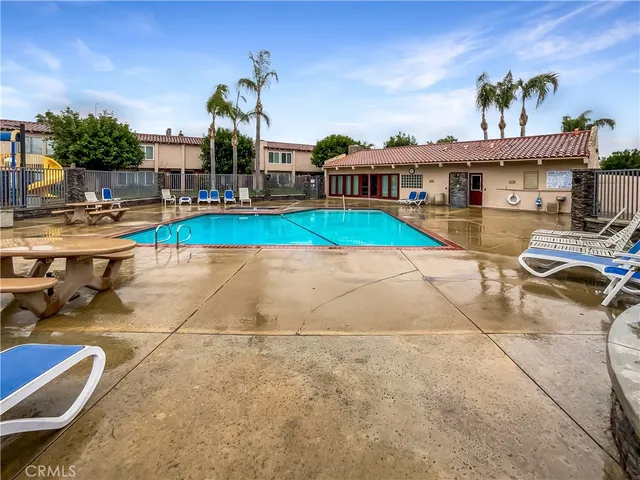 a view of swimming pool with outdoor seating and a patio