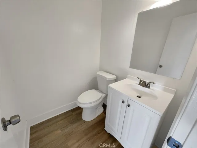 a white toilet sitting next to a white sink