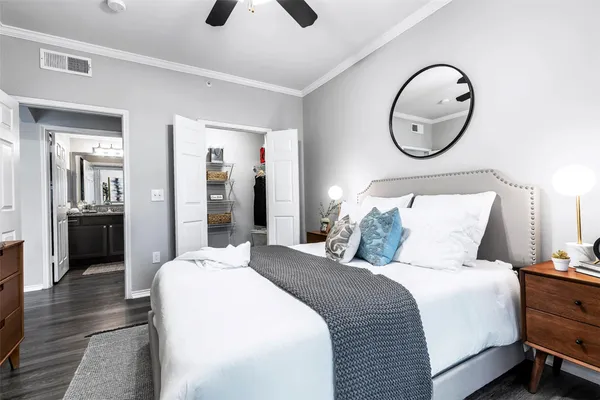 a bedroom with bed and a chandelier