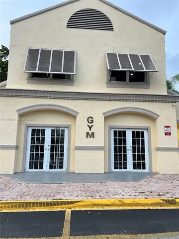 a view of a brick house with large windows