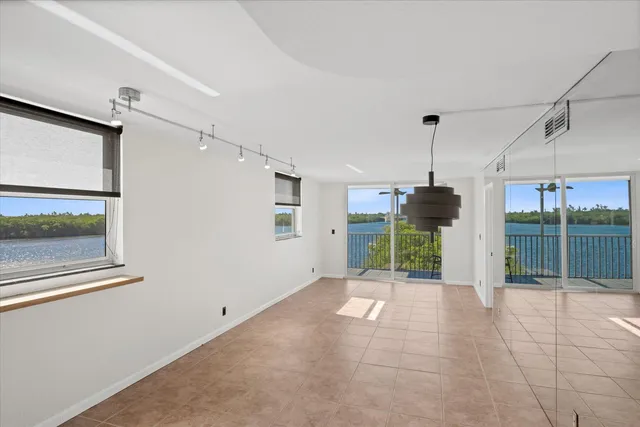 a view of a livingroom with a floor to ceiling window and wooden floor