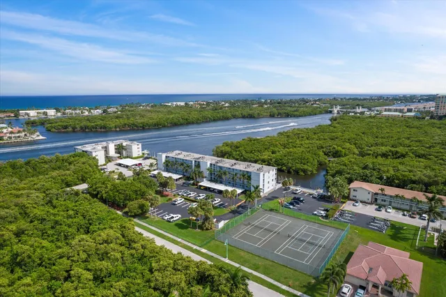 an aerial view of a house with a garden and lake view
