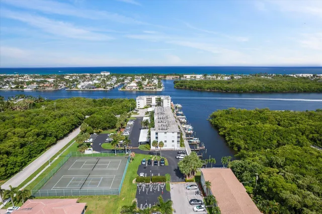 an aerial view of a house with a garden and lake view