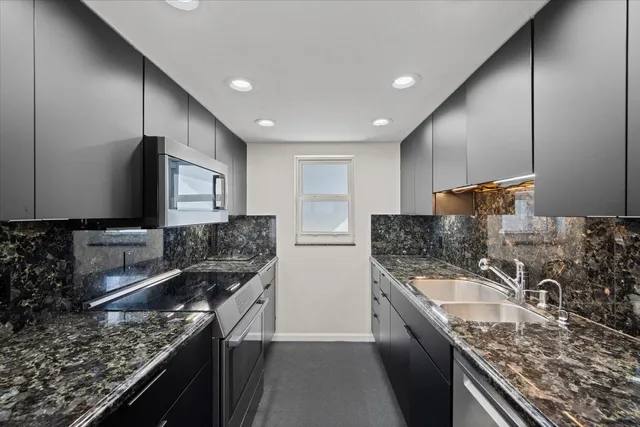 a kitchen with a sink stove top oven and cabinets