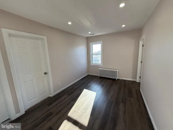 a view of wooden floor and windows in a room