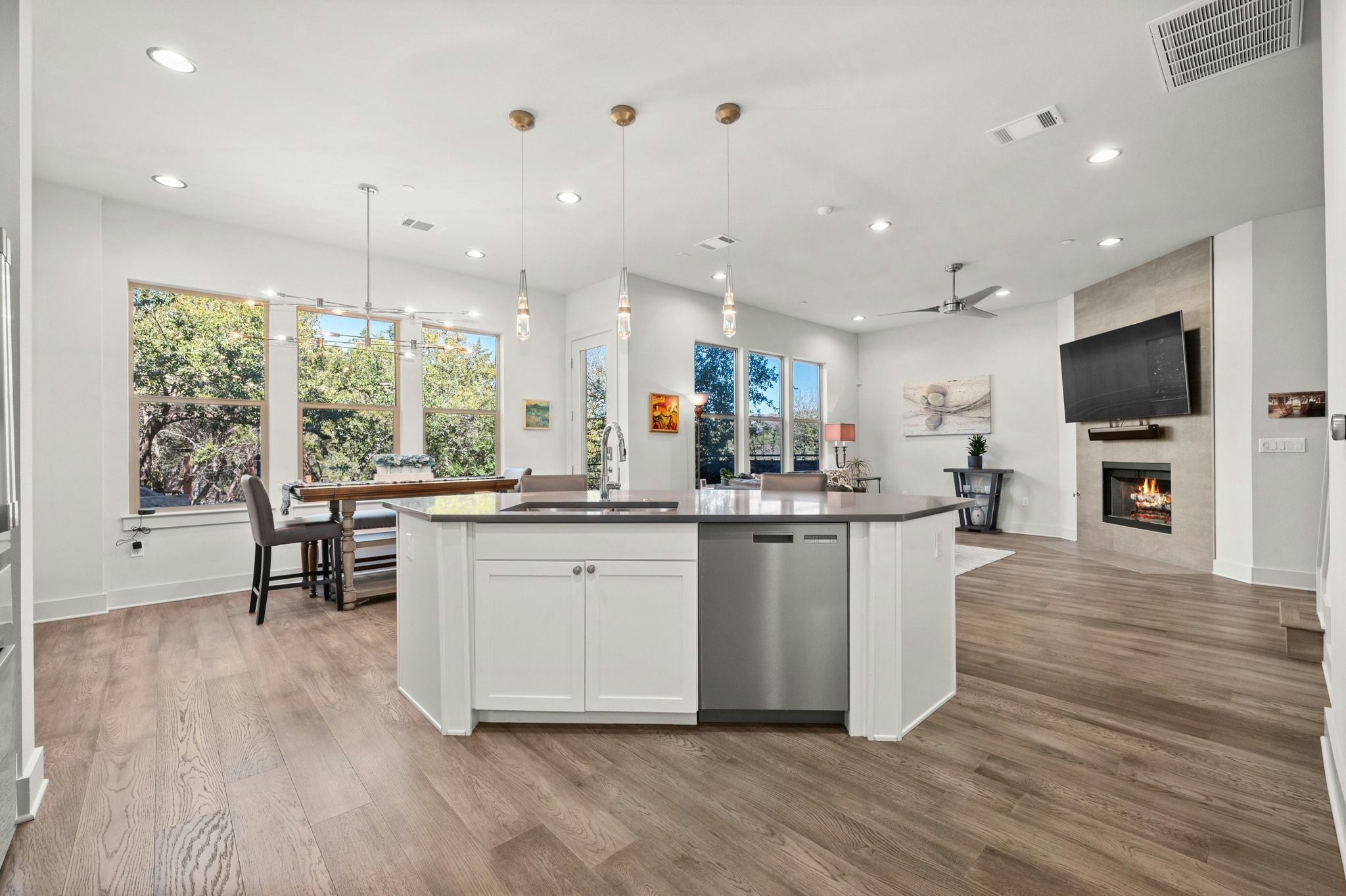 8110 Ranch Road 2222, Unit 92 Austin, TX 78730 - Photo 11 of 40 Open-concept living space featuring wood-finish flooring, recessed lighting, and large windows