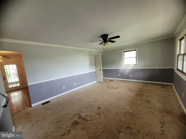 an empty room with a empty space and windows