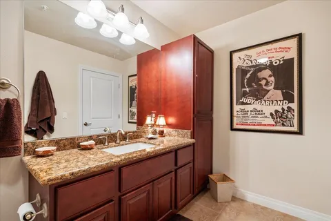 a bathroom with a sink vanity and a mirror