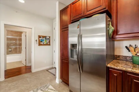 a kitchen with stainless steel appliances granite countertop a refrigerator and a sink