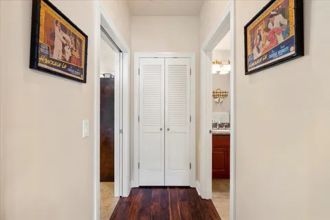 a view of a hallway with wooden floor