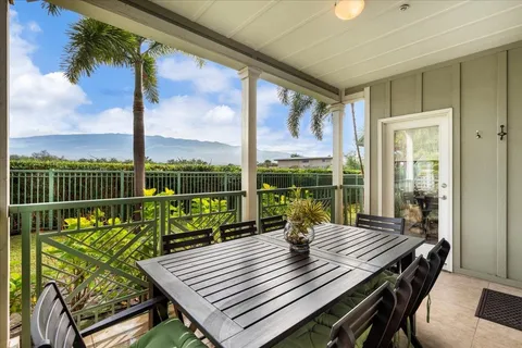 a view of a balcony with floor to ceiling windows with wooden floor