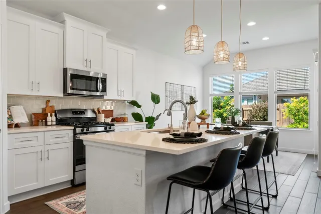 a kitchen with a sink cabinets and wooden floor