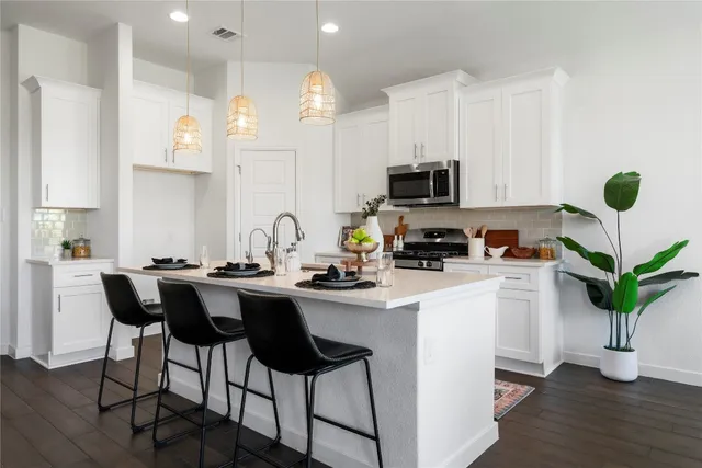 a kitchen with a refrigerator and microwave
