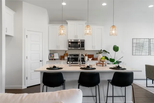 a kitchen with a sink and a stove top oven