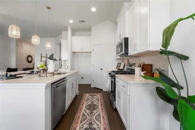 a dining room with kitchen island furniture a chandelier and kitchen view