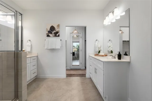 a spacious bathroom with a double vanity sink and a mirror