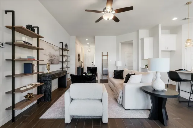 a living room with furniture a rug and a chandelier