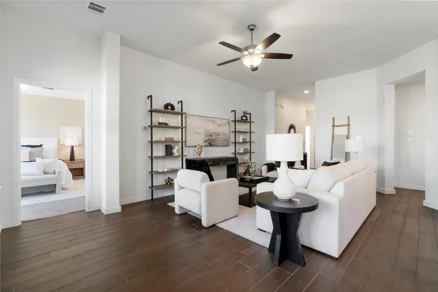 a living room with furniture a rug and a wall painting