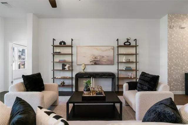a living room with furniture and a kitchen view
