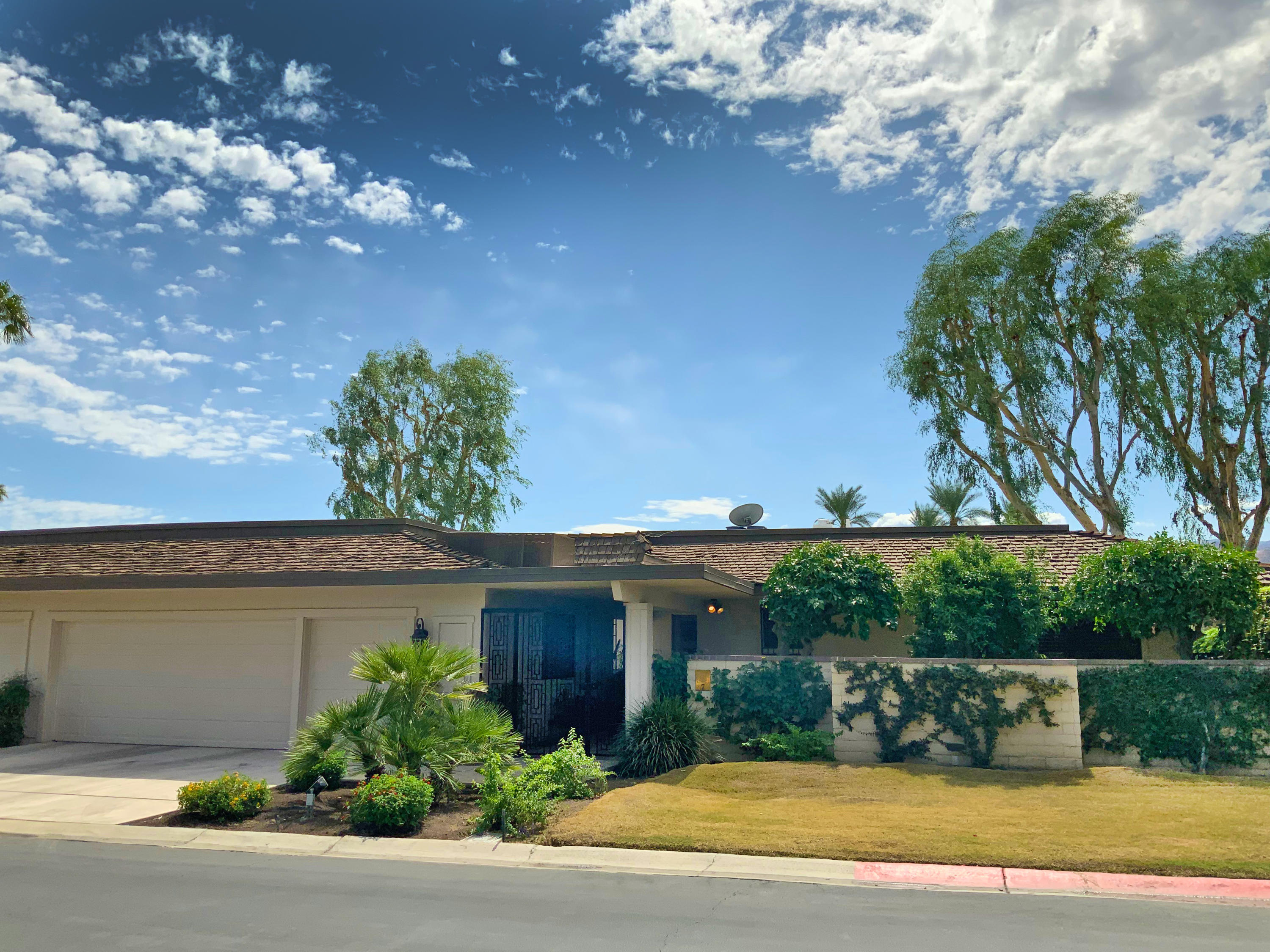 7 Princeton Drive Rancho Mirage, CA 92270 - Photo 39 of 39 a front view of a house with a yard and a garage