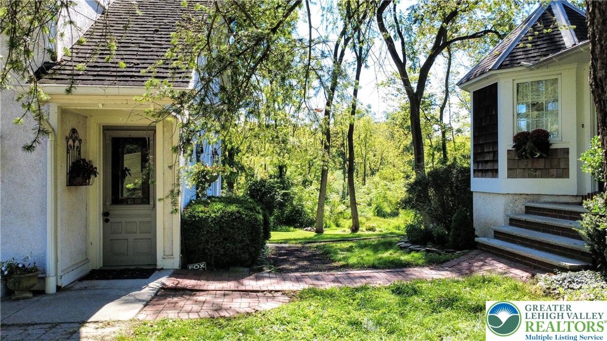 1731 Howell Road Easton, PA 18040 - Photo 4 of 60 Mature trees frame a charming brick pathway leading to the inviting entrance of this home.
