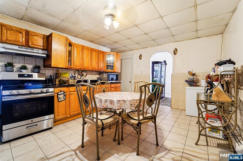 514 Madison Avenue Elizabeth, NJ 07201 - Photo 10 of 14 a kitchen with stainless steel appliances granite countertop a stove a sink dishwasher and a refrigerator