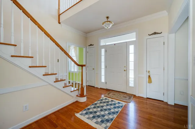 a view of empty room with wooden floor and fireplace