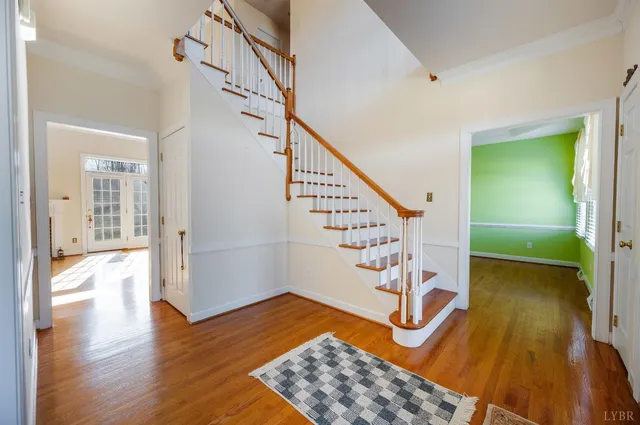 a view of a room with wooden floor and a staircase