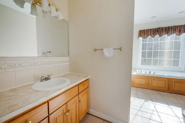 a bathroom with a sink toilet vanity and shower