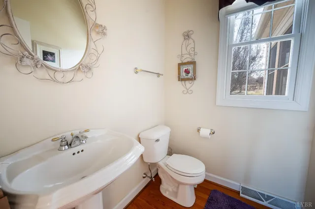 a view of an empty room with wooden floor and closet