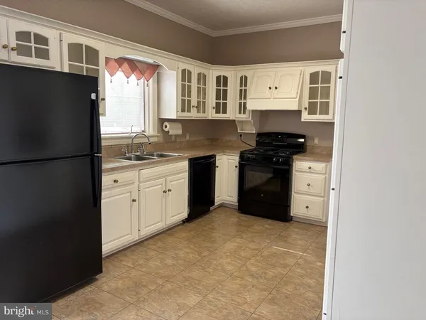 a kitchen with stainless steel appliances granite countertop a refrigerator and a stove