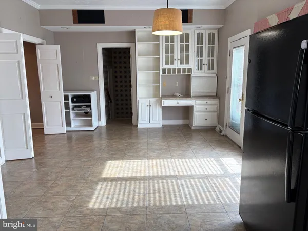 a kitchen with stainless steel appliances a refrigerator and cabinets