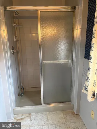 a bathroom with a glass door shower
