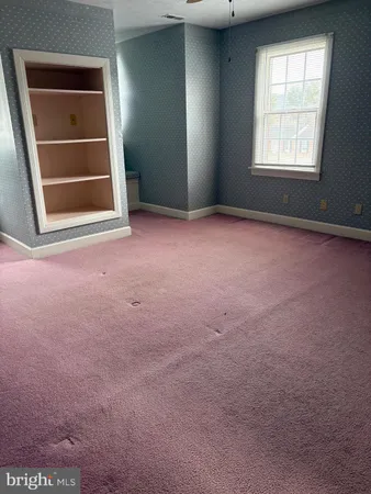 an empty room with windows and closet