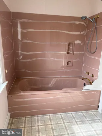 a bathroom with a white bath tub