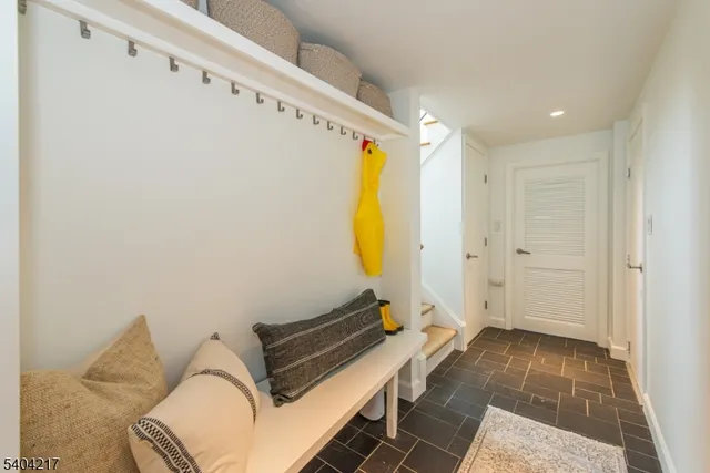 a living room with furniture and a lamp