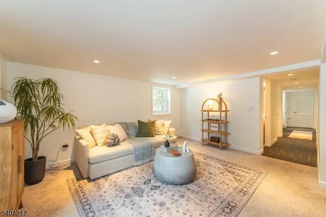 a bedroom with a bed a potted plant and a window