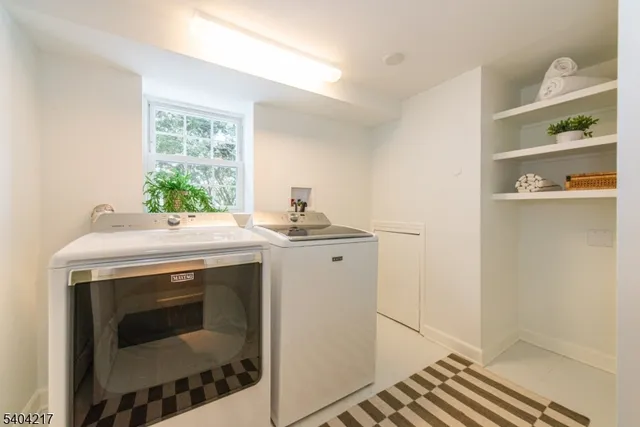 a bathroom with a white bath tub a sink and a shower