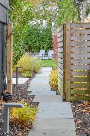 a view of a swimming pool with chairs in patio
