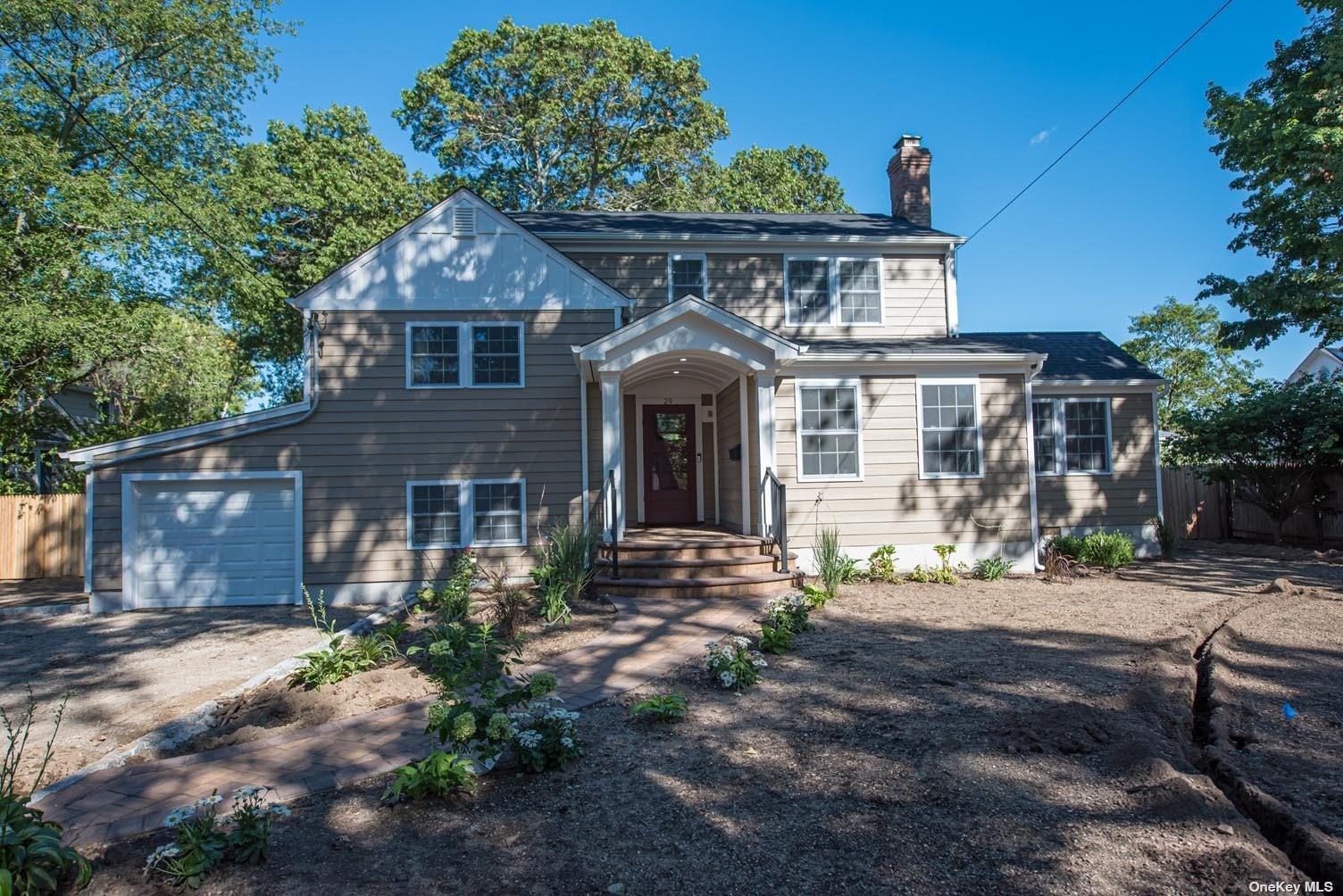 29 Parkwood Road West Islip, NY 11795 - Photo 1 of 1 a front view of a house with a garden