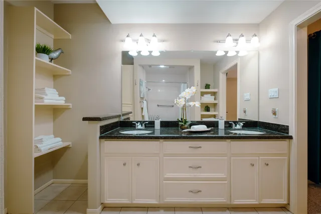 a bathroom with a sink double vanity and a mirror