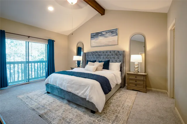 a bedroom with a large bed and a window