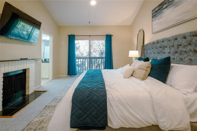 a bed sitting in a bedroom next to a window